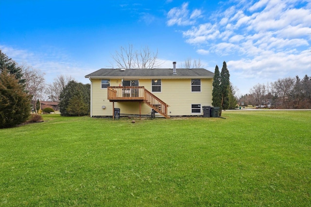 back of house featuring a deck and a lawn