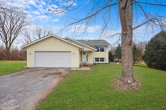 view of front of property featuring a garage and a front yard