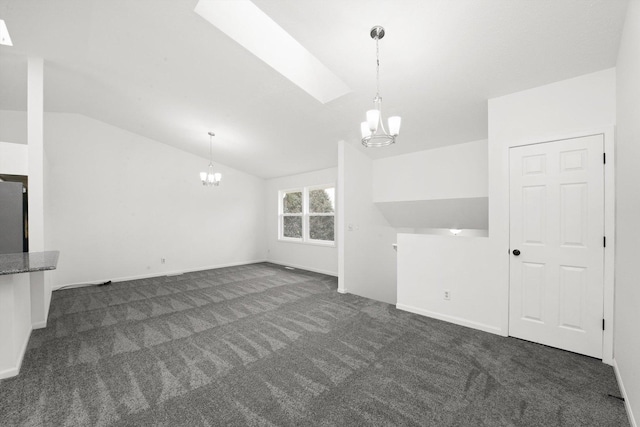 unfurnished living room with dark colored carpet, vaulted ceiling, and a notable chandelier