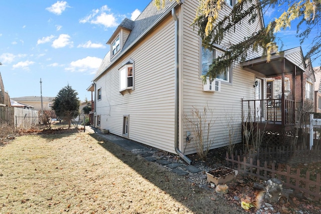 view of side of property with a yard