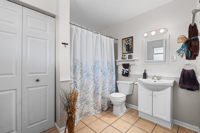 bathroom featuring tile patterned flooring, vanity, a shower with curtain, and toilet