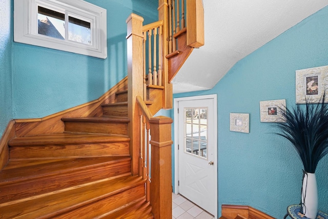 stairway with lofted ceiling