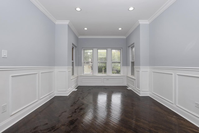 empty room featuring crown molding and dark hardwood / wood-style flooring