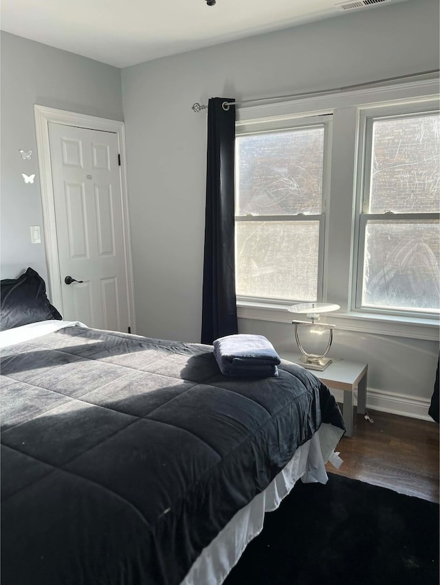 bedroom with hardwood / wood-style floors