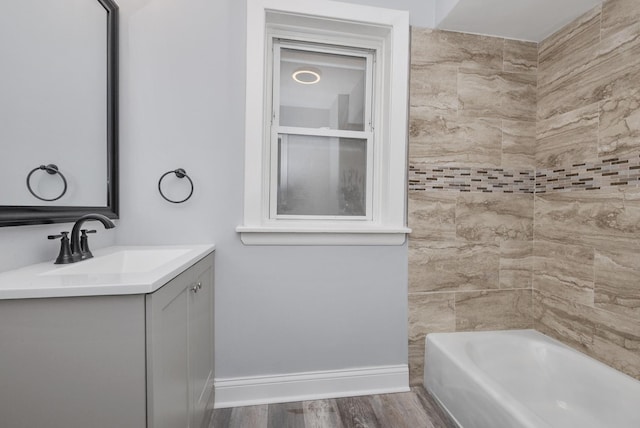 bathroom with vanity, hardwood / wood-style flooring, and tiled shower / bath combo