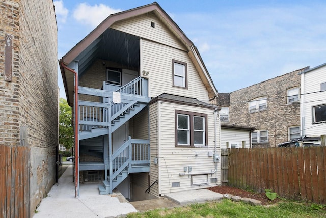 rear view of property featuring a balcony