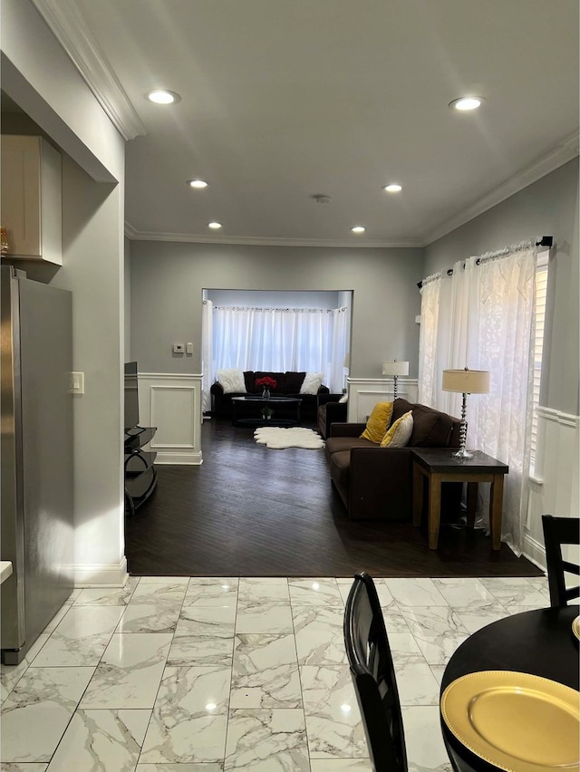 living room featuring ornamental molding and a healthy amount of sunlight