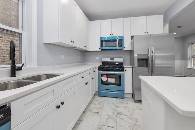 kitchen with white cabinetry, sink, crown molding, and appliances with stainless steel finishes