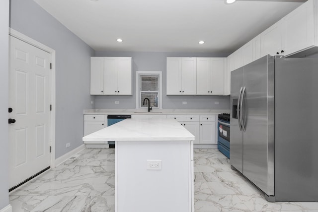 kitchen featuring white cabinetry, sink, a center island, stainless steel appliances, and light stone countertops