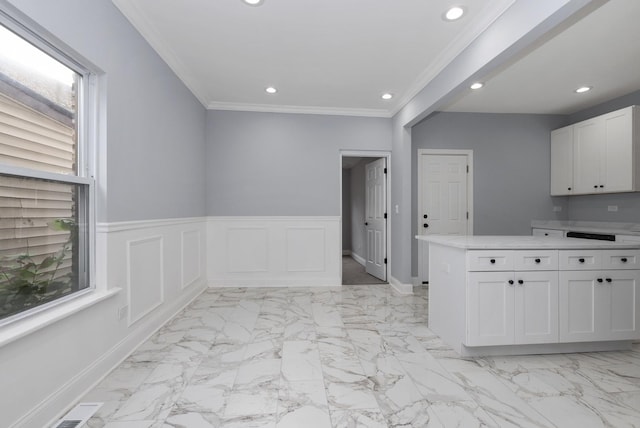 kitchen featuring crown molding, a wealth of natural light, kitchen peninsula, and white cabinets