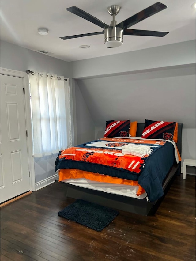 bedroom featuring dark hardwood / wood-style floors and vaulted ceiling