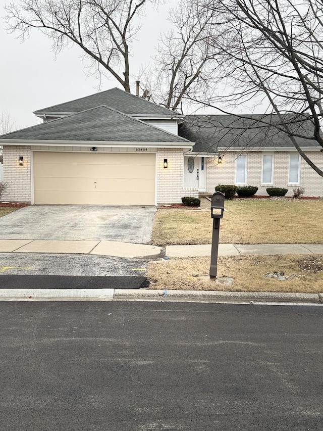 view of front of property with a garage and a front yard