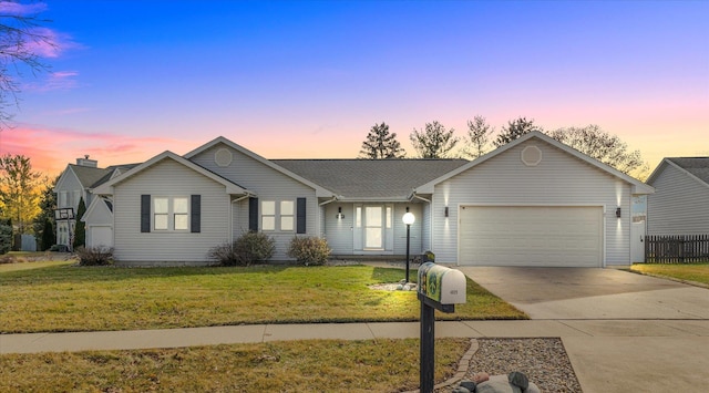 ranch-style home with a yard and a garage