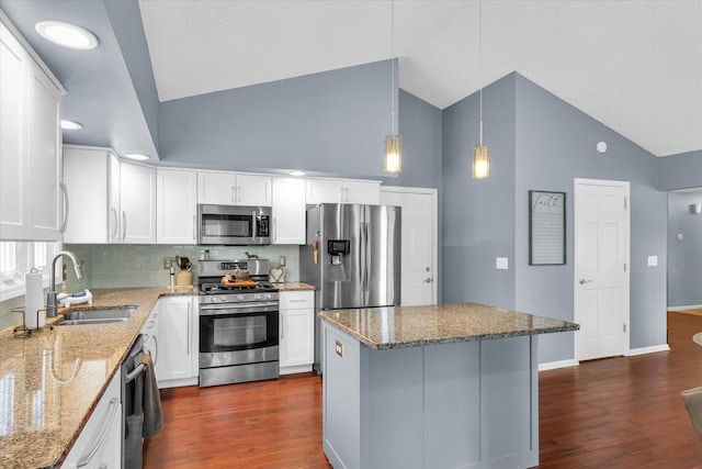 kitchen featuring sink, white cabinetry, hanging light fixtures, stainless steel appliances, and a center island