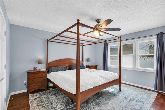 bedroom featuring ceiling fan, dark wood-type flooring, and a textured ceiling