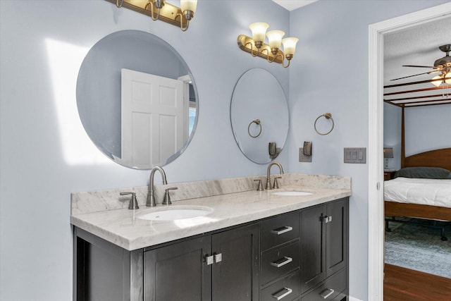 bathroom with vanity, hardwood / wood-style floors, and ceiling fan