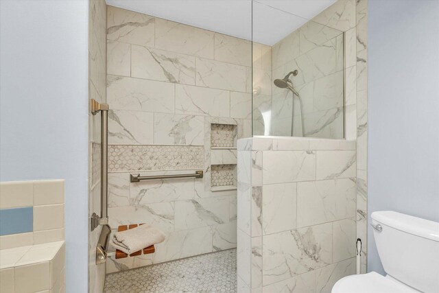 bathroom featuring toilet and tiled shower