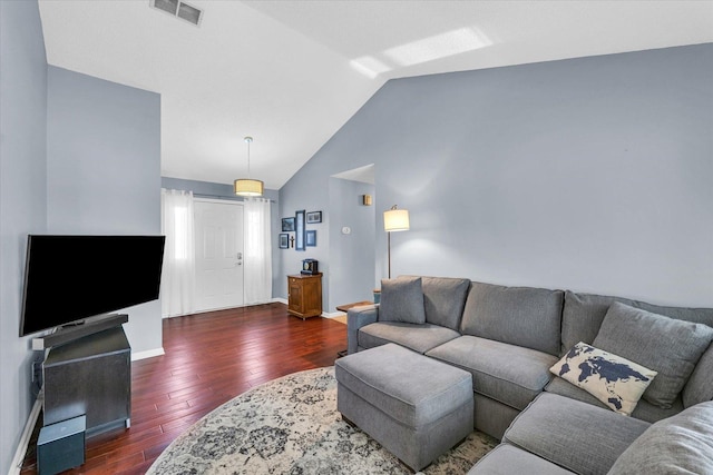 living room featuring dark wood-type flooring and lofted ceiling