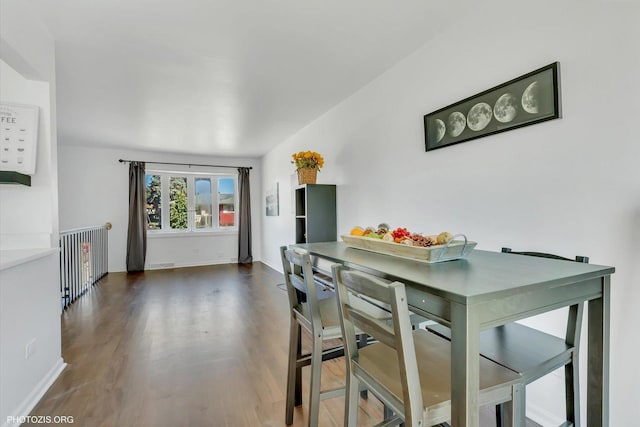 dining space with dark hardwood / wood-style flooring