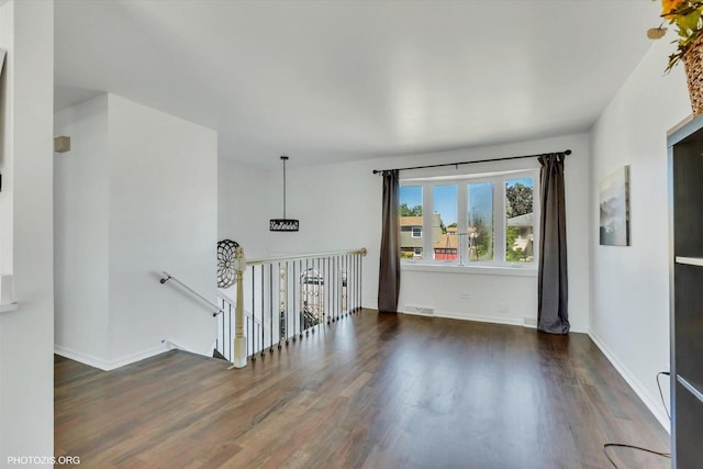 unfurnished room featuring dark wood-type flooring