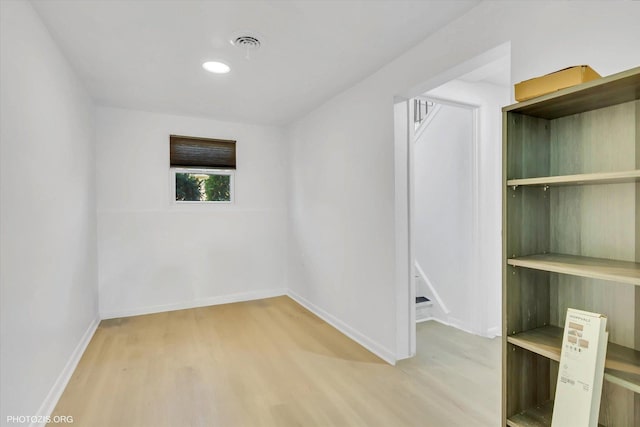 unfurnished room with hardwood / wood-style flooring