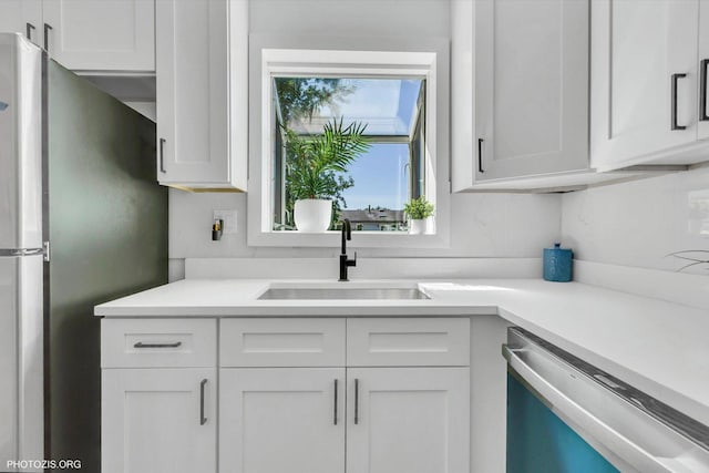 kitchen featuring white cabinetry, sink, and stainless steel appliances