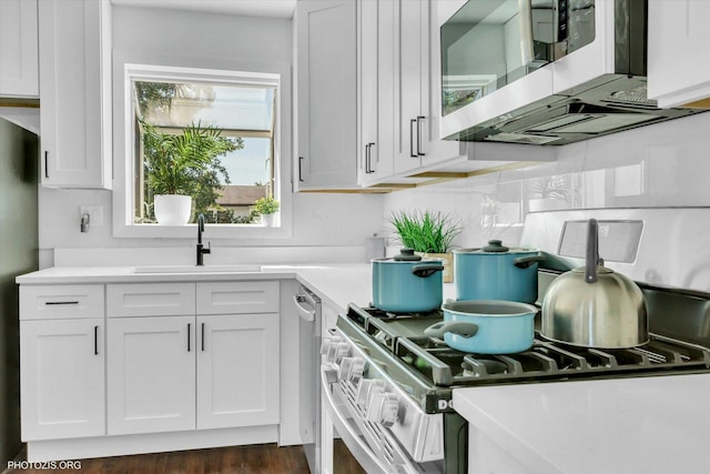 kitchen featuring white cabinetry, sink, and backsplash