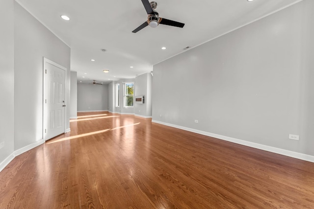 unfurnished living room featuring hardwood / wood-style floors and ceiling fan