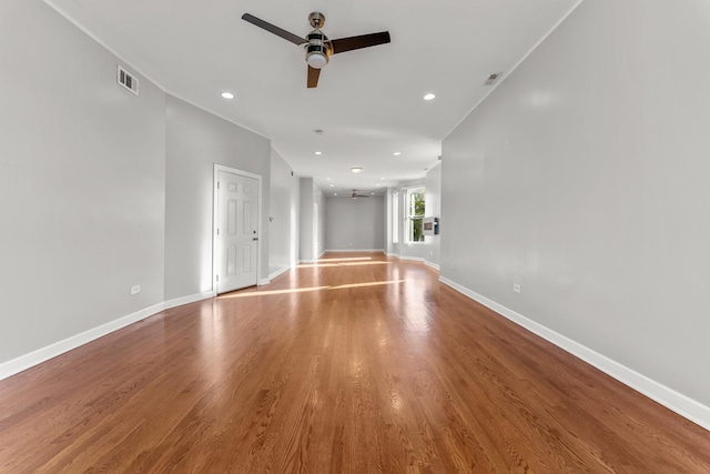 unfurnished living room featuring wood-type flooring and ceiling fan