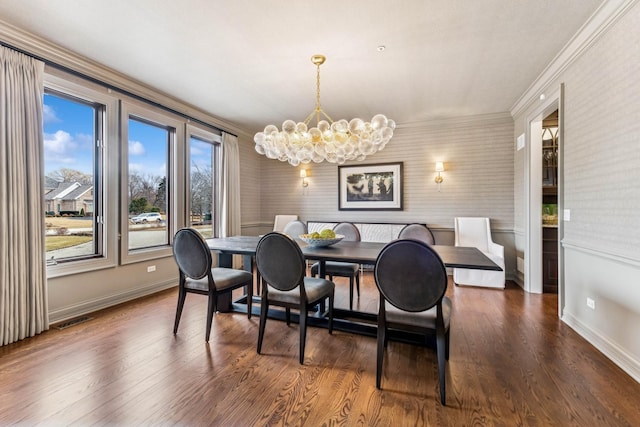 dining room featuring crown molding, an inviting chandelier, and dark hardwood / wood-style flooring