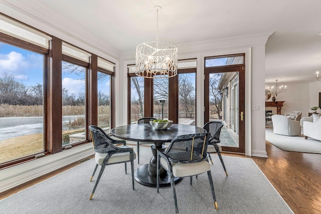 dining room featuring an inviting chandelier, crown molding, and plenty of natural light