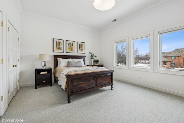 bedroom with light carpet and crown molding