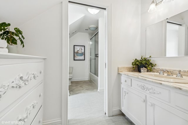 full bathroom featuring vanity, lofted ceiling, toilet, and combined bath / shower with glass door