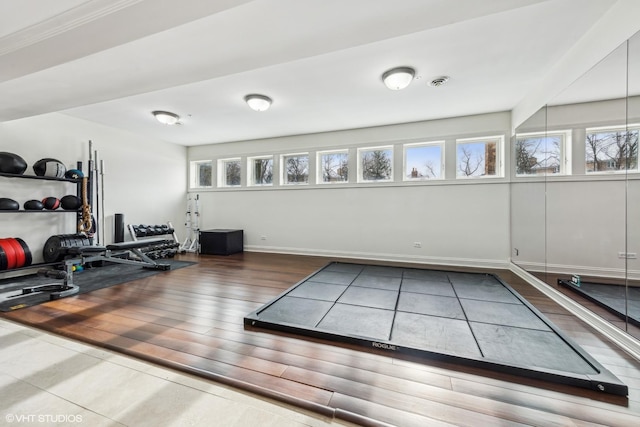 exercise room with hardwood / wood-style floors