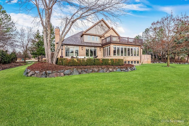 back of house with a balcony and a lawn