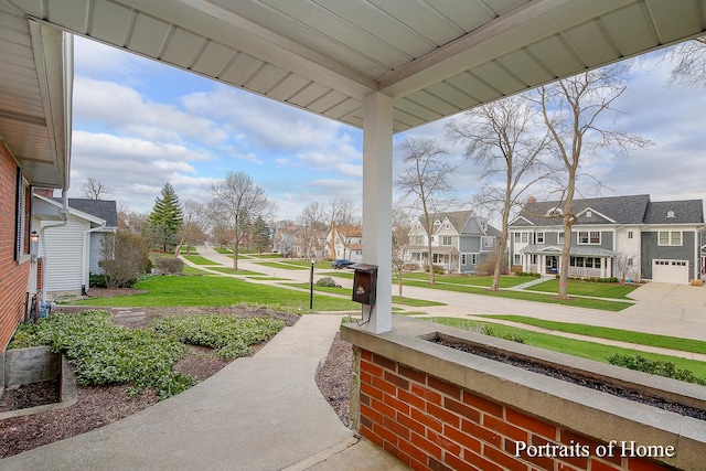 view of community with a residential view and a lawn