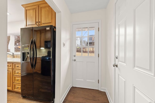 entryway with a sink, dark wood finished floors, and baseboards