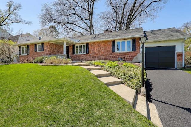 ranch-style house with a front lawn, brick siding, driveway, and an attached garage