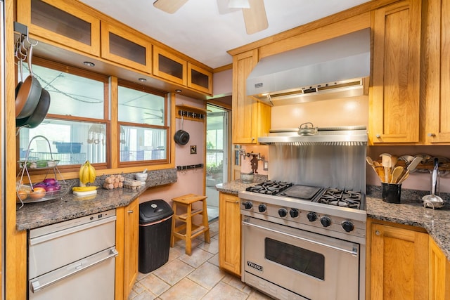 kitchen featuring premium range, ceiling fan, light tile patterned flooring, exhaust hood, and dark stone counters