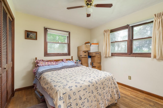 bedroom featuring light hardwood / wood-style flooring, a closet, and ceiling fan