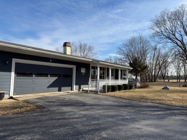 ranch-style home with a garage and a porch