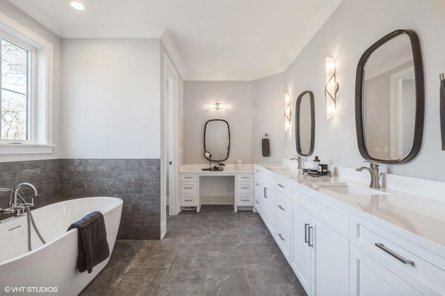 bathroom featuring vanity, a tub, and tile walls