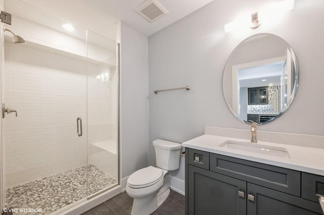 bathroom featuring vanity, an enclosed shower, tile patterned floors, and toilet