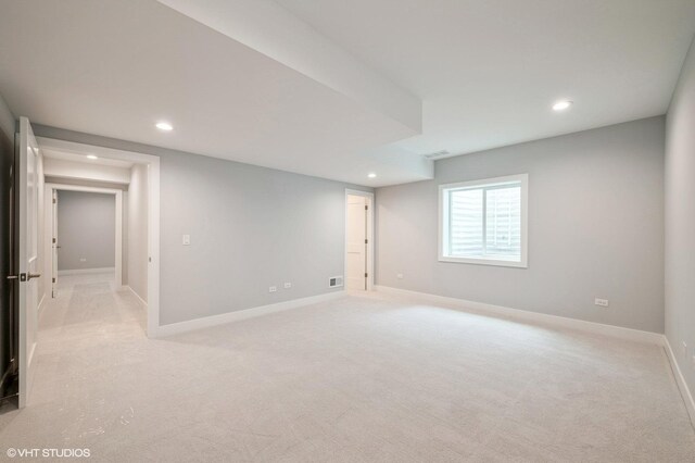 basement featuring light carpet