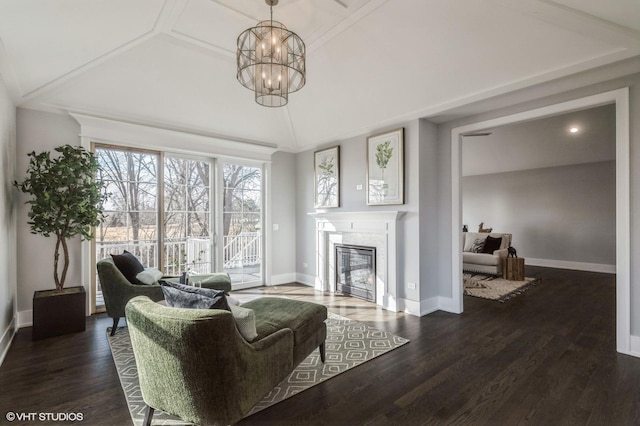 living room featuring lofted ceiling, dark hardwood / wood-style floors, and a chandelier