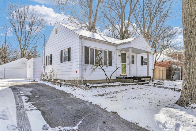 view of front of property featuring a garage and an outbuilding