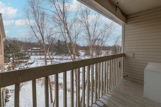 view of snow covered back of property