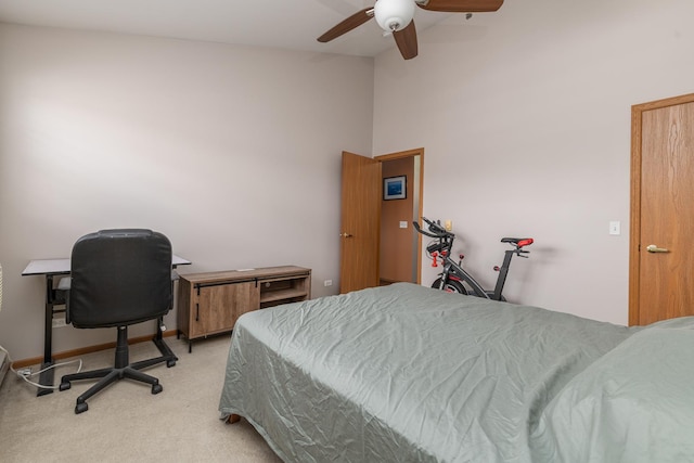 bedroom with light carpet, a ceiling fan, and baseboards