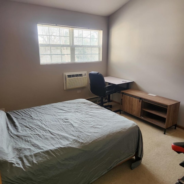 bedroom featuring a wall mounted AC and light carpet