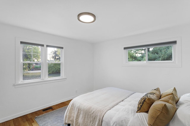 bedroom with hardwood / wood-style flooring